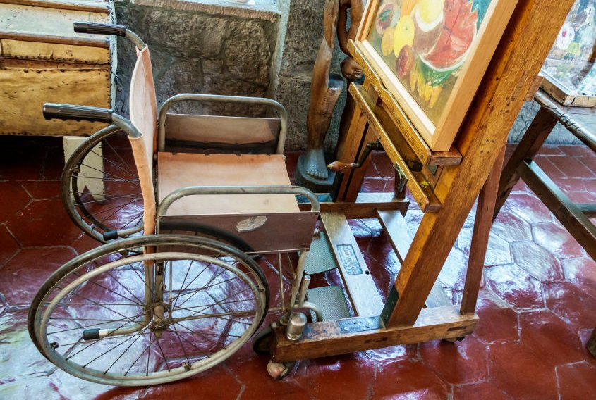 A wheelchair easel inside the blue house at the Frida Kahlo Museum