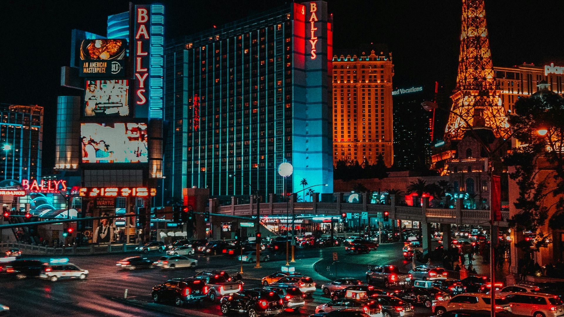 cars on road near high rise buildings during night time