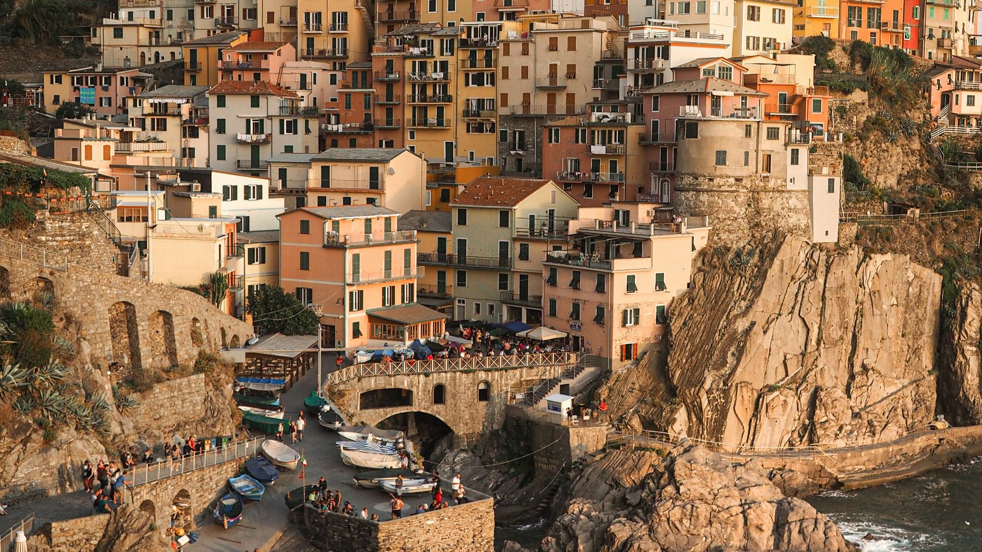 white and brown concrete houses near body of water during daytime