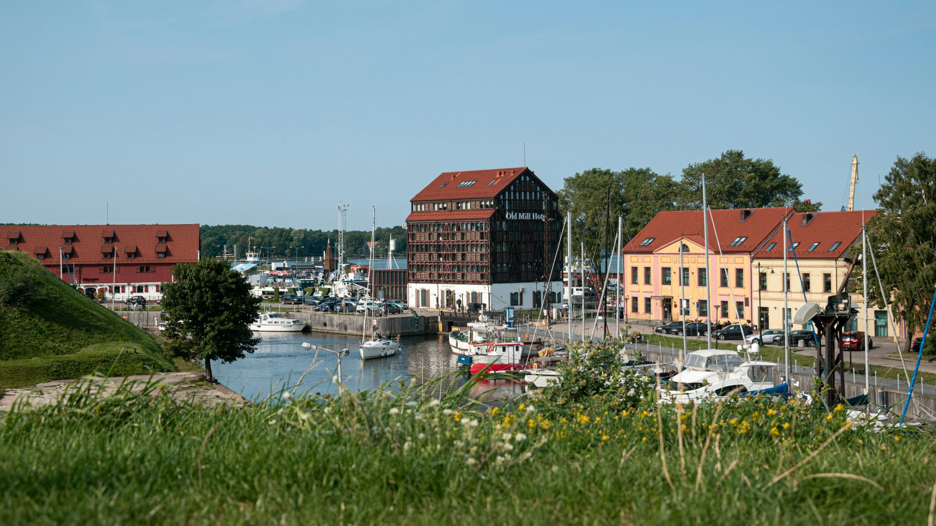 red and white houses near body of water during daytime