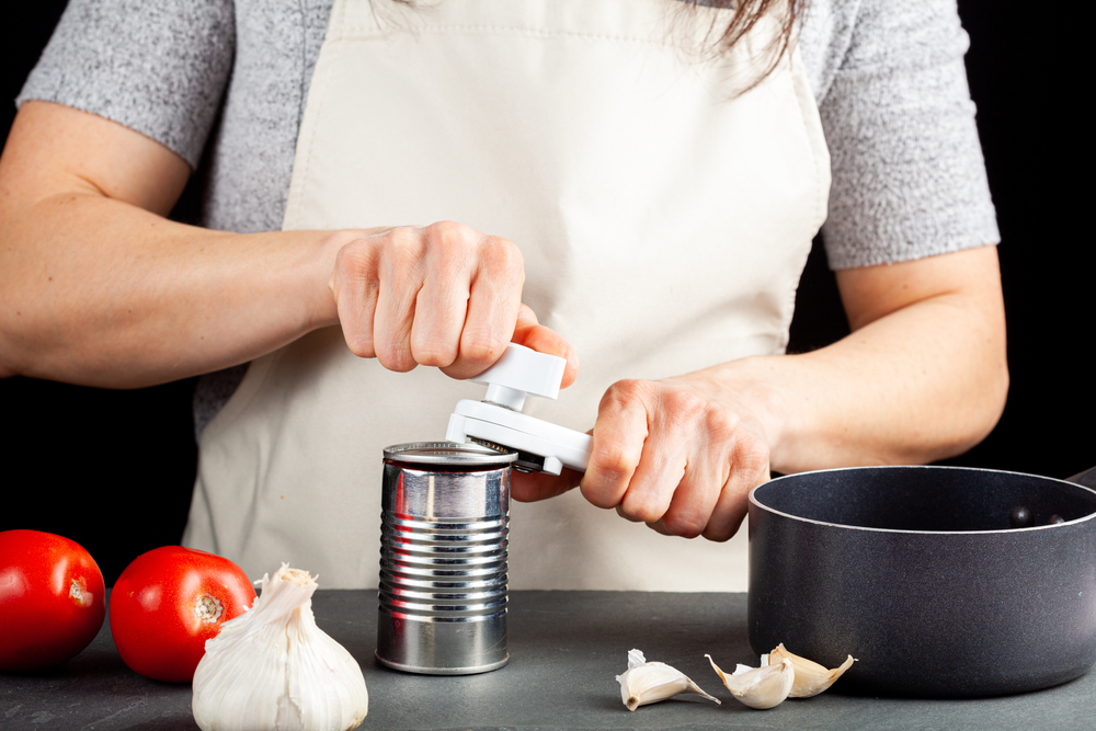 Woman using a can opener