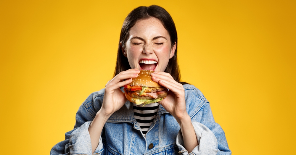 Woman eating hamburger