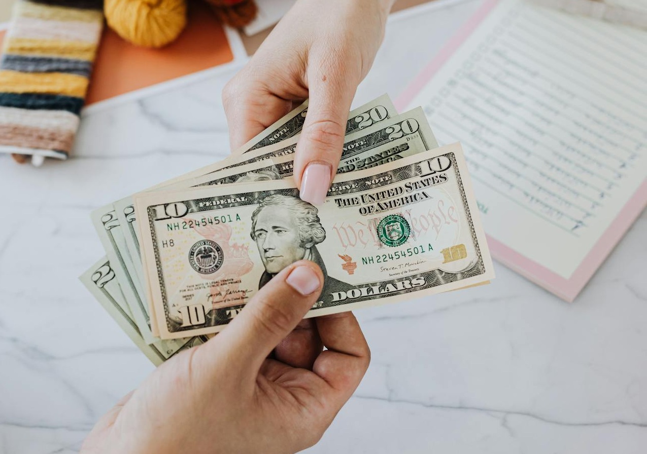 Hands Exchanging Dollars
