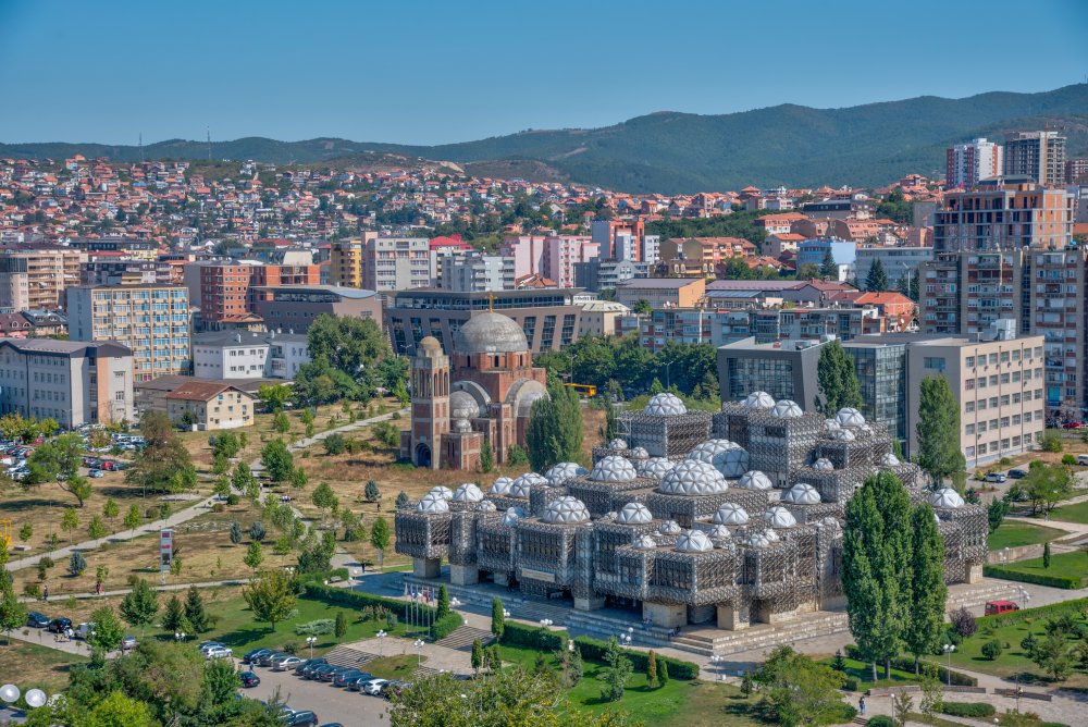 The image showcases a Vibrant urban scene of Pristina, Kosovo