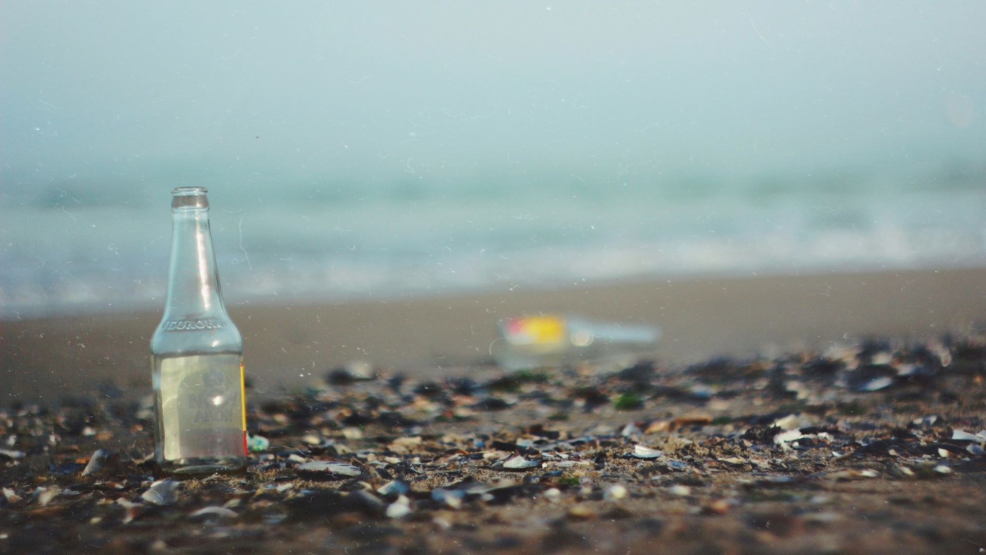 glass bottle on sea shore