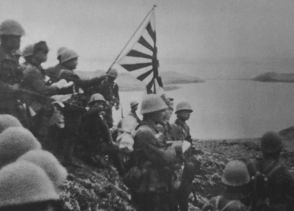 Japanese troops raise the Imperial battle flag