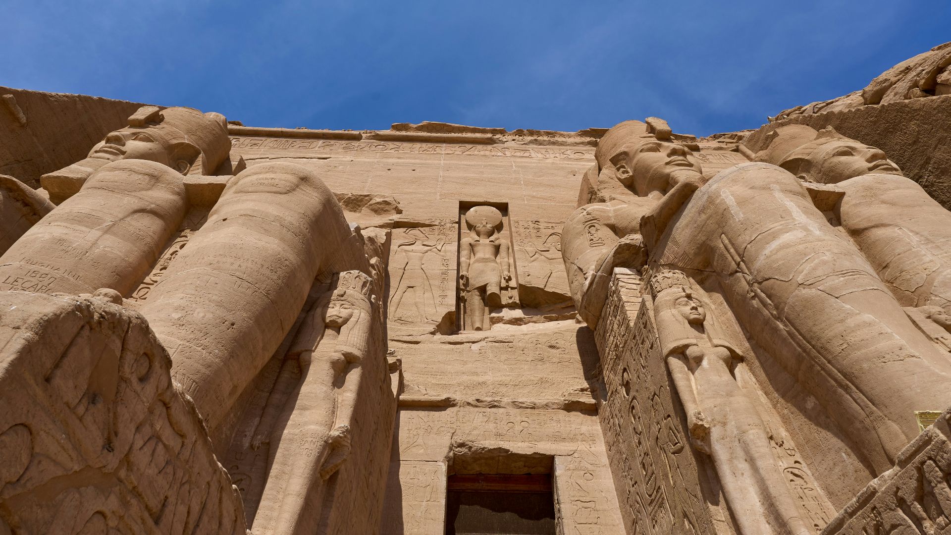 a tall building with statues on the side of it