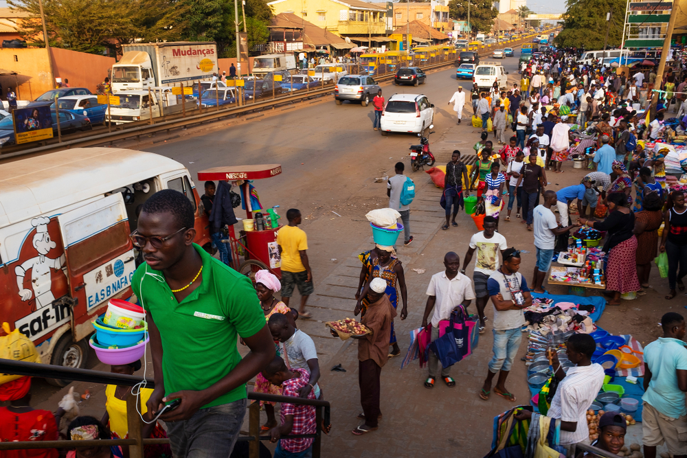 Street scene in the city of Bissau with people at the Bandim Market, in Guinea-Bissau