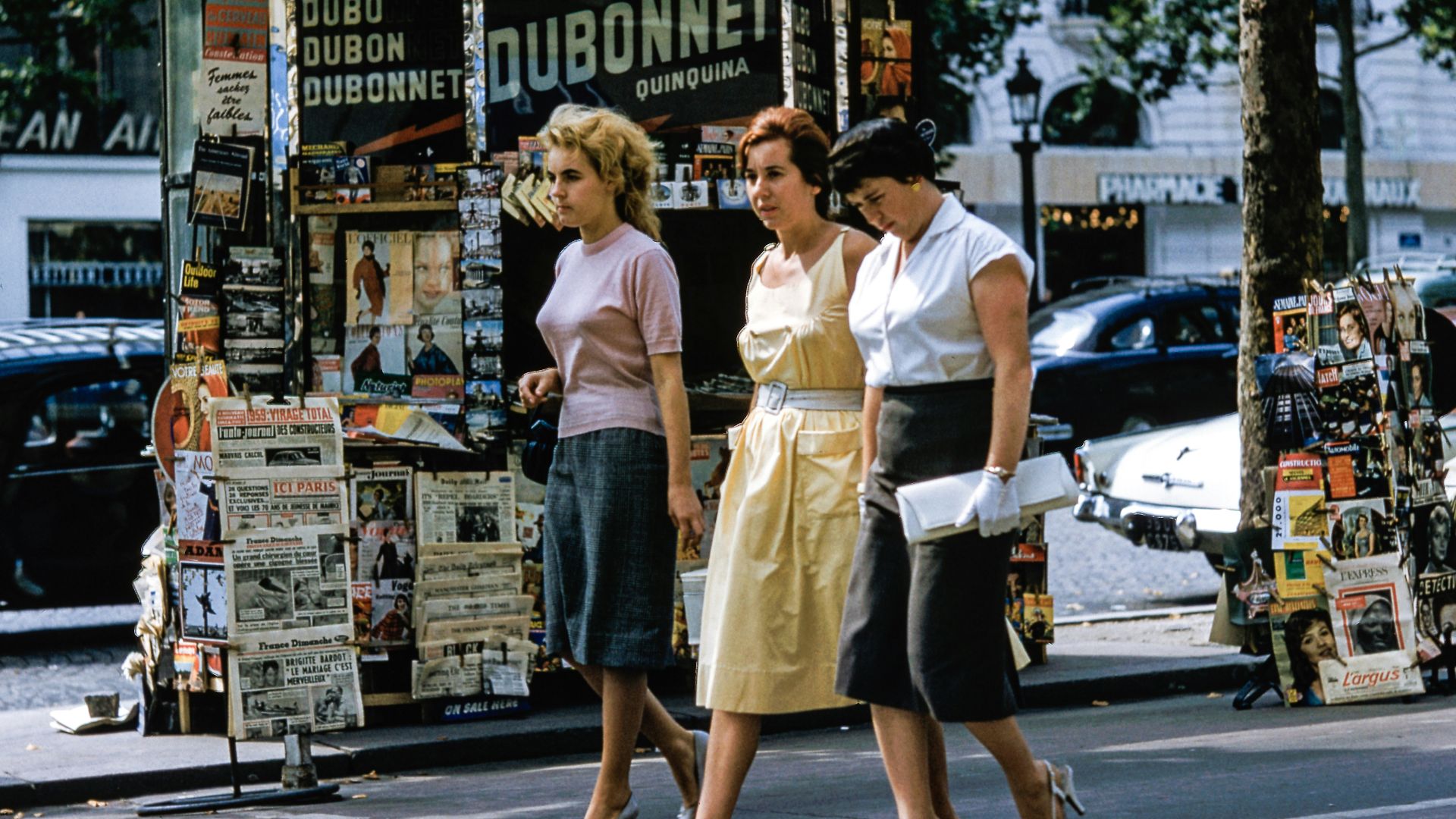three women walking on road