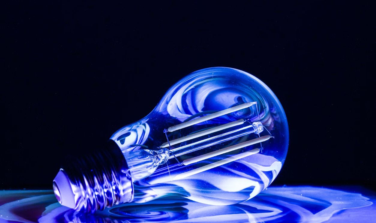 Illuminated light bulb in blue cool tones.