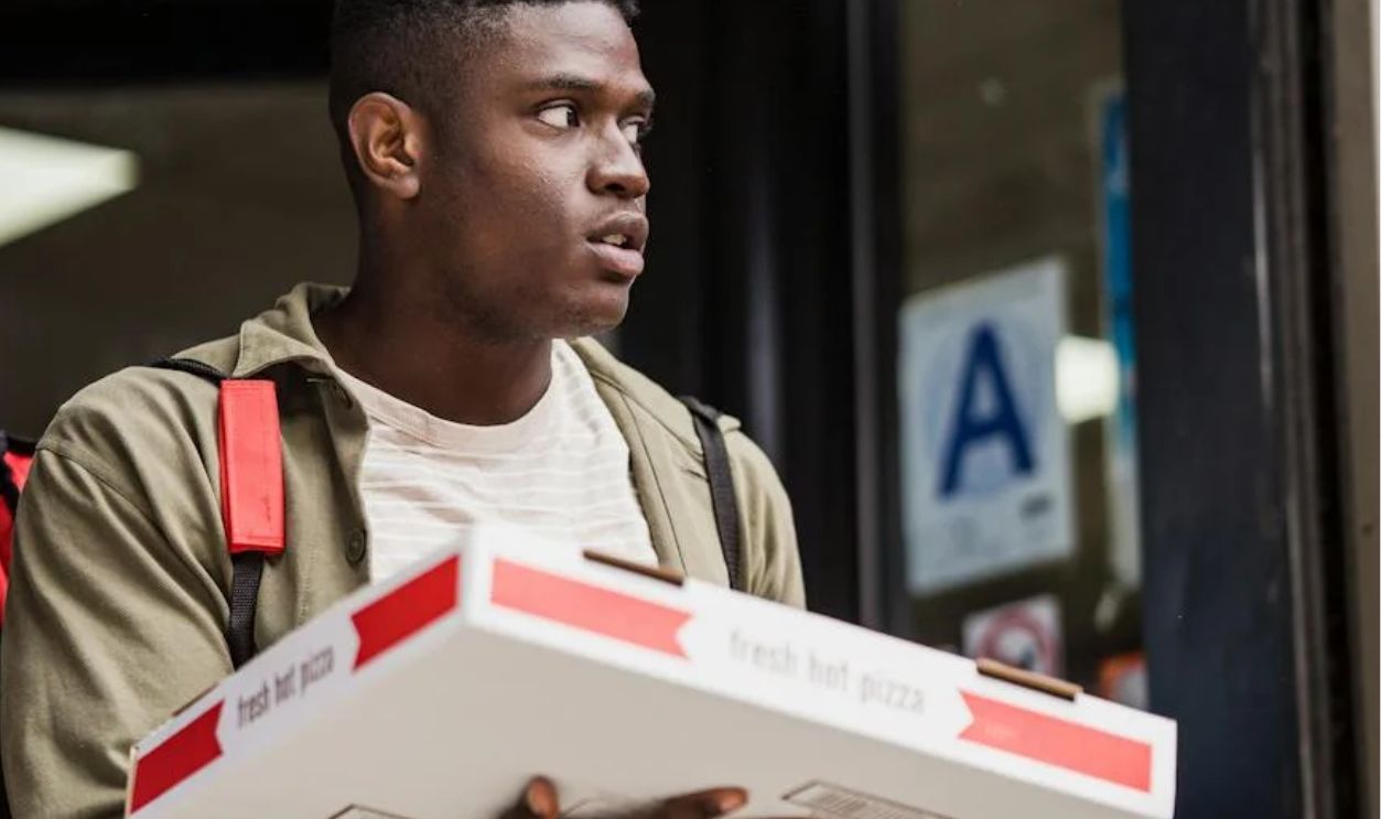 Delivery Man Carrying Ordered Pizza