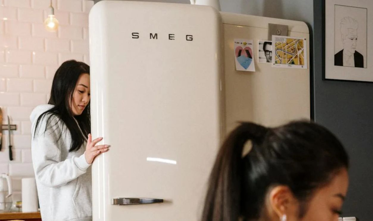 Woman opening a refrigerator