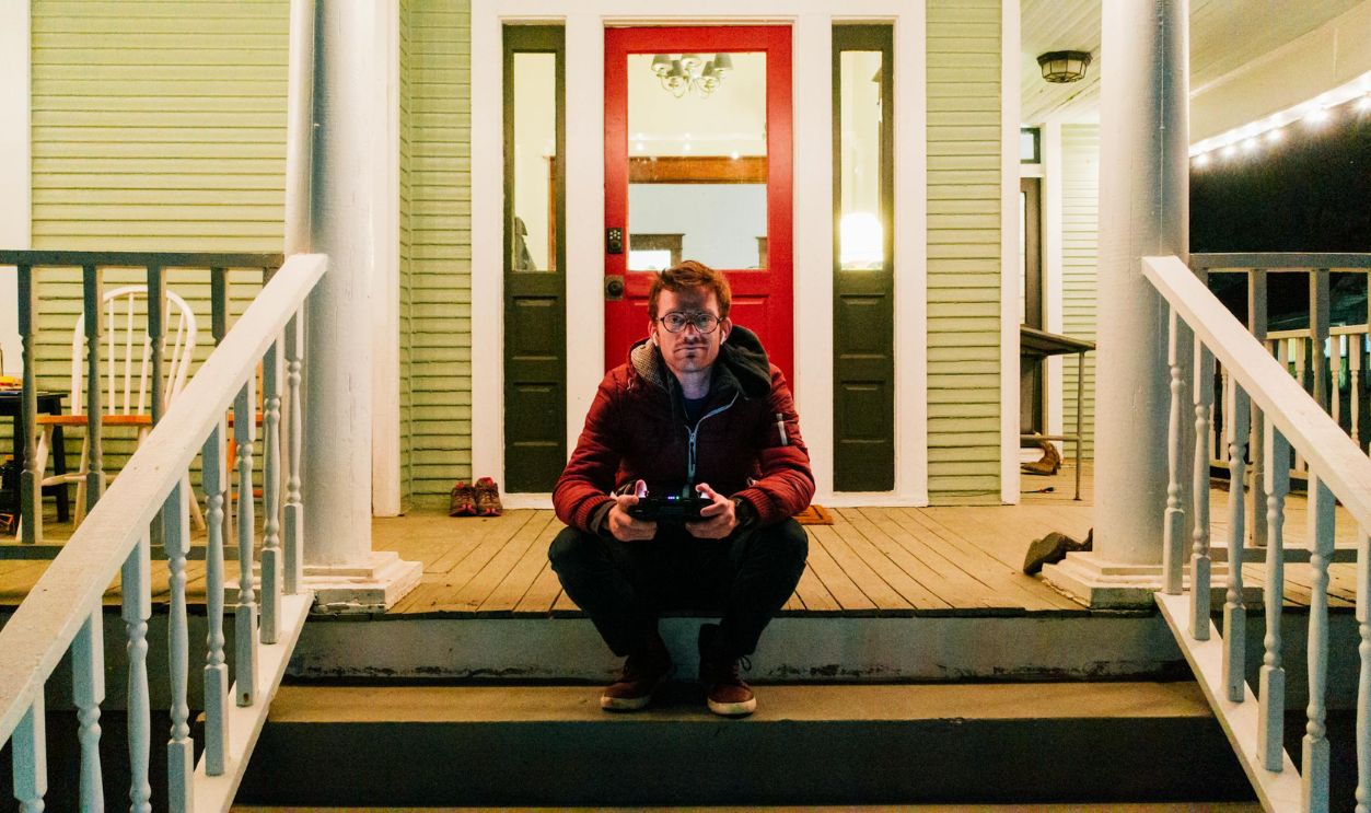 A man in front of his house