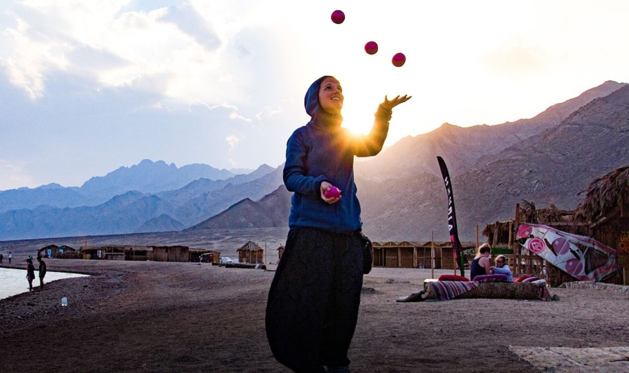 A woman juggling balls