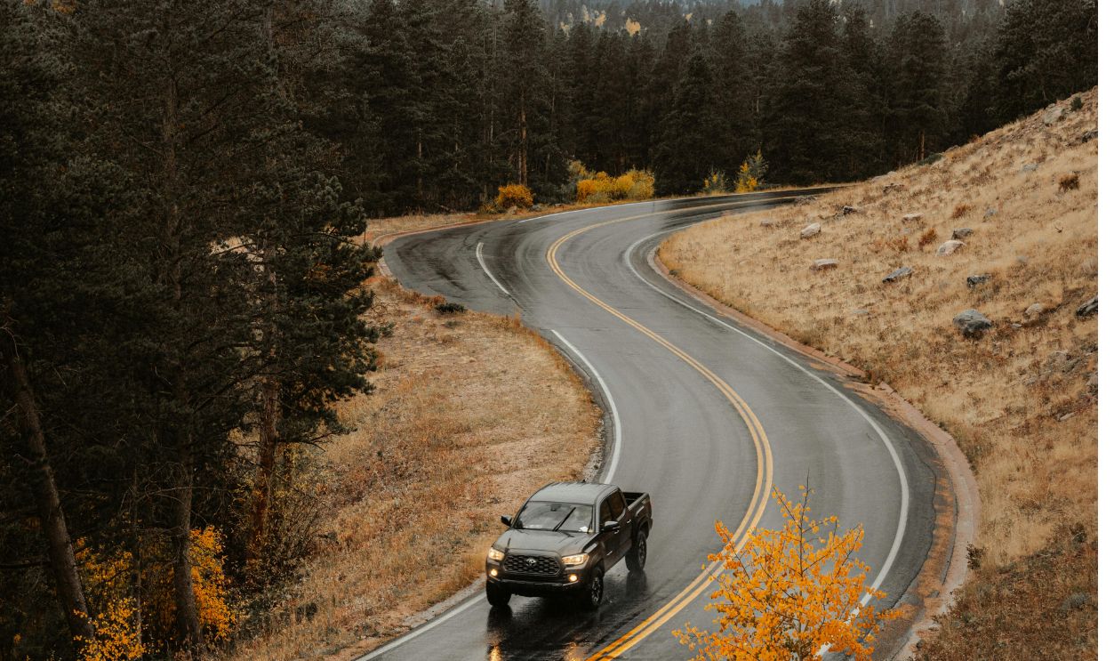 Car Driving Through Road in Mountains
