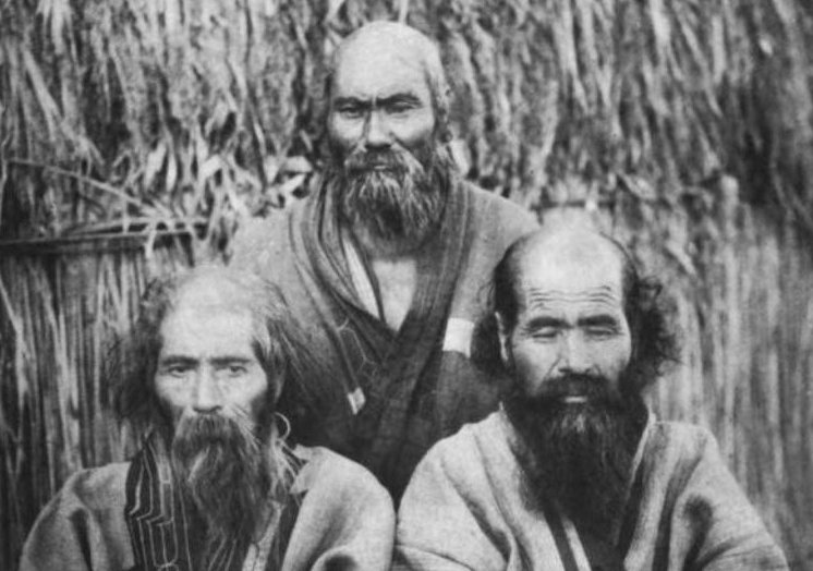 Three Ainu men in traditional clothing