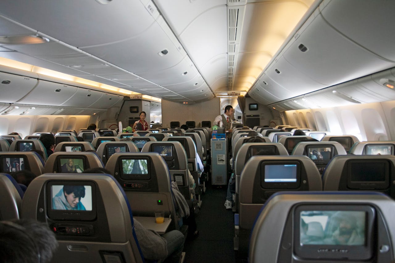 Flight Attendants with Snacks Between Airliners Seats