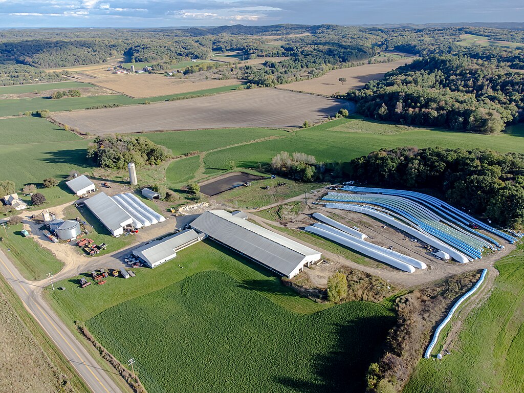 The image is a high-angle aerial view of a large agricultural complex