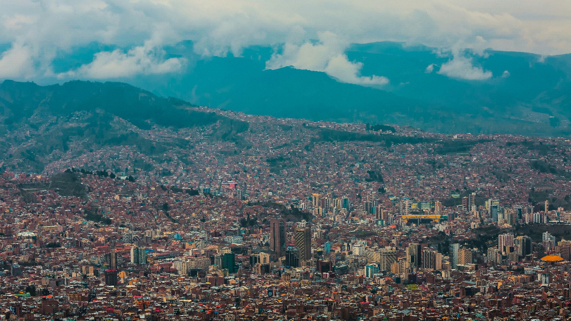 village houses and city buildings under white clouds during daytime