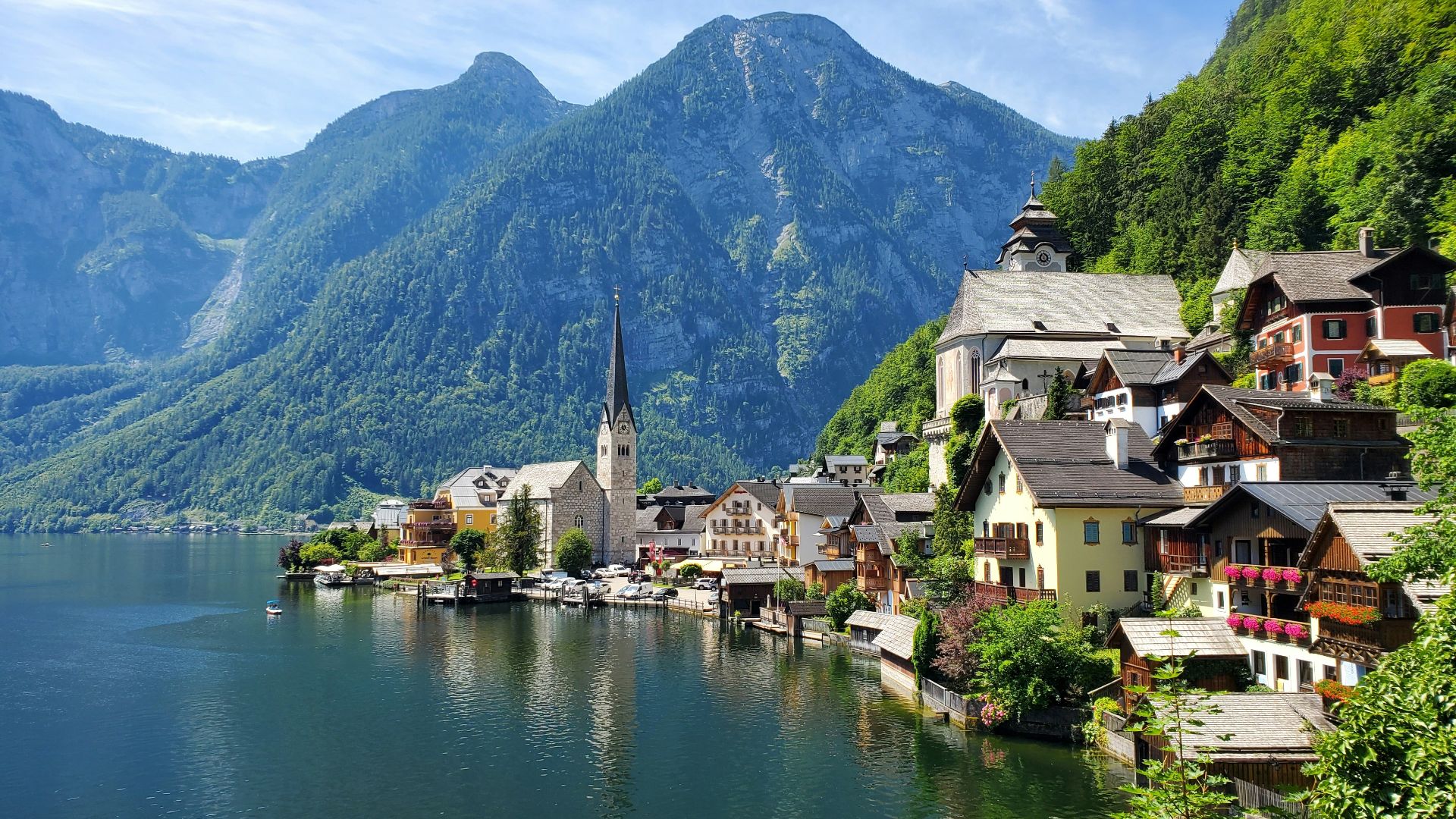 houses near body of water and mountain during daytime