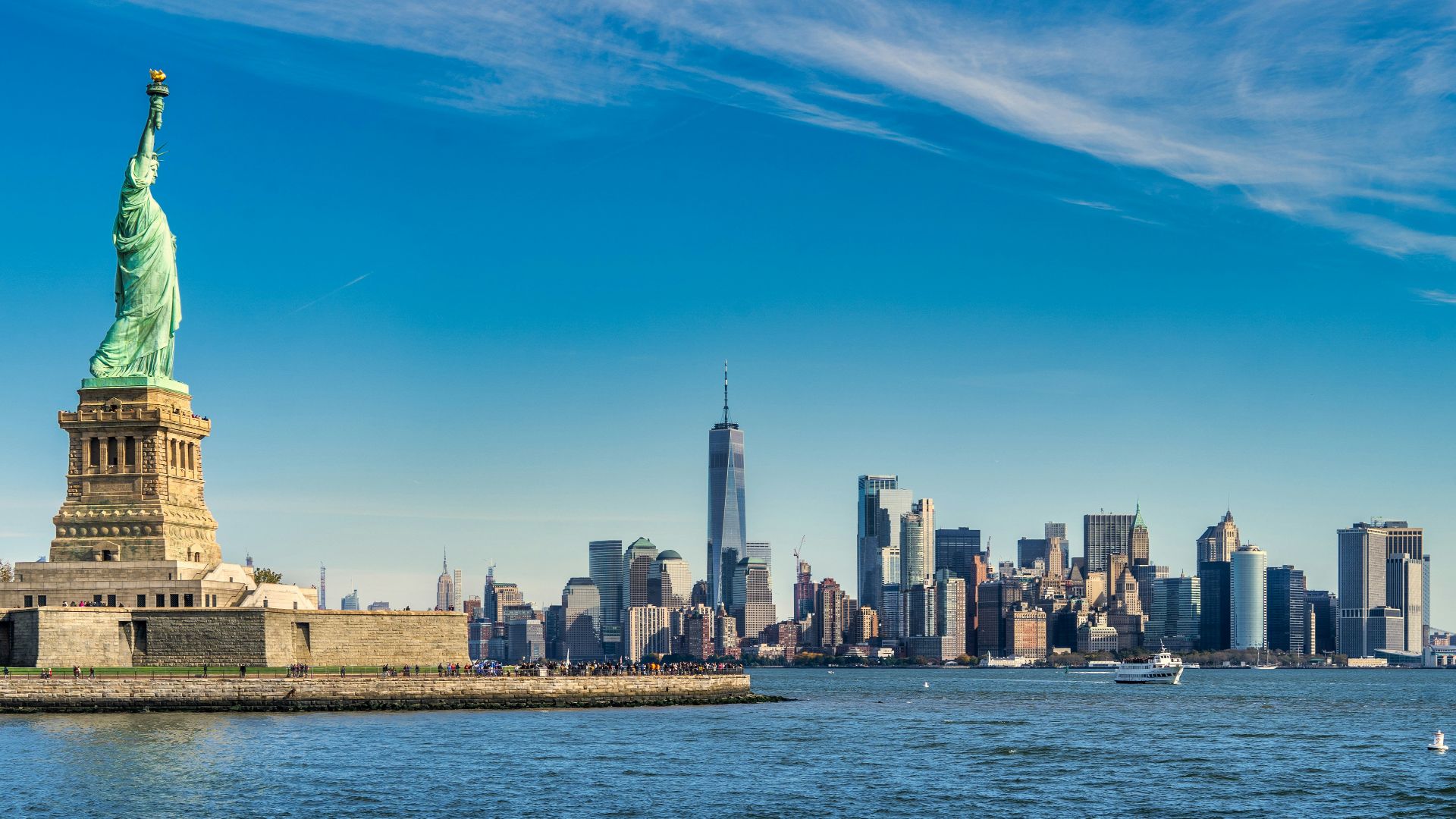 city skyline across body of water during daytime