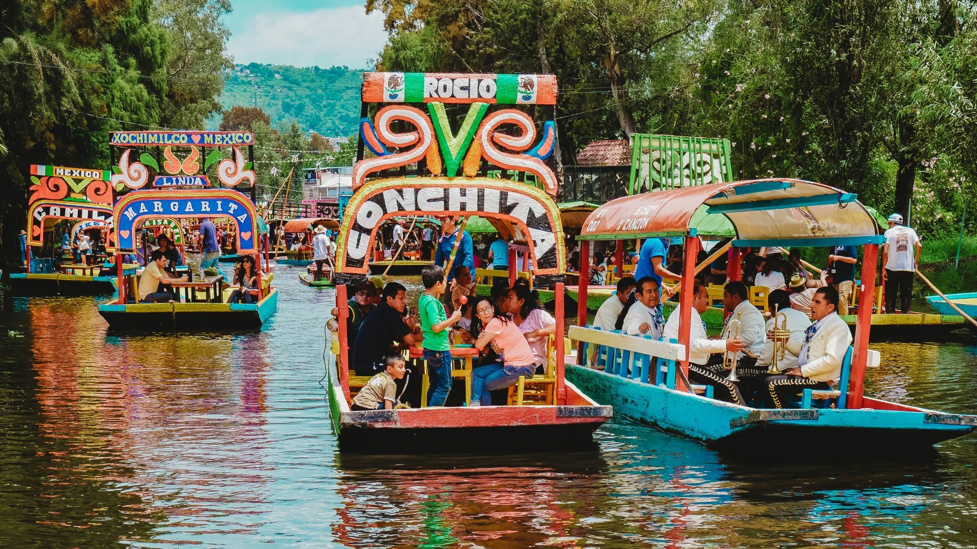 people riding tour boats during daytime