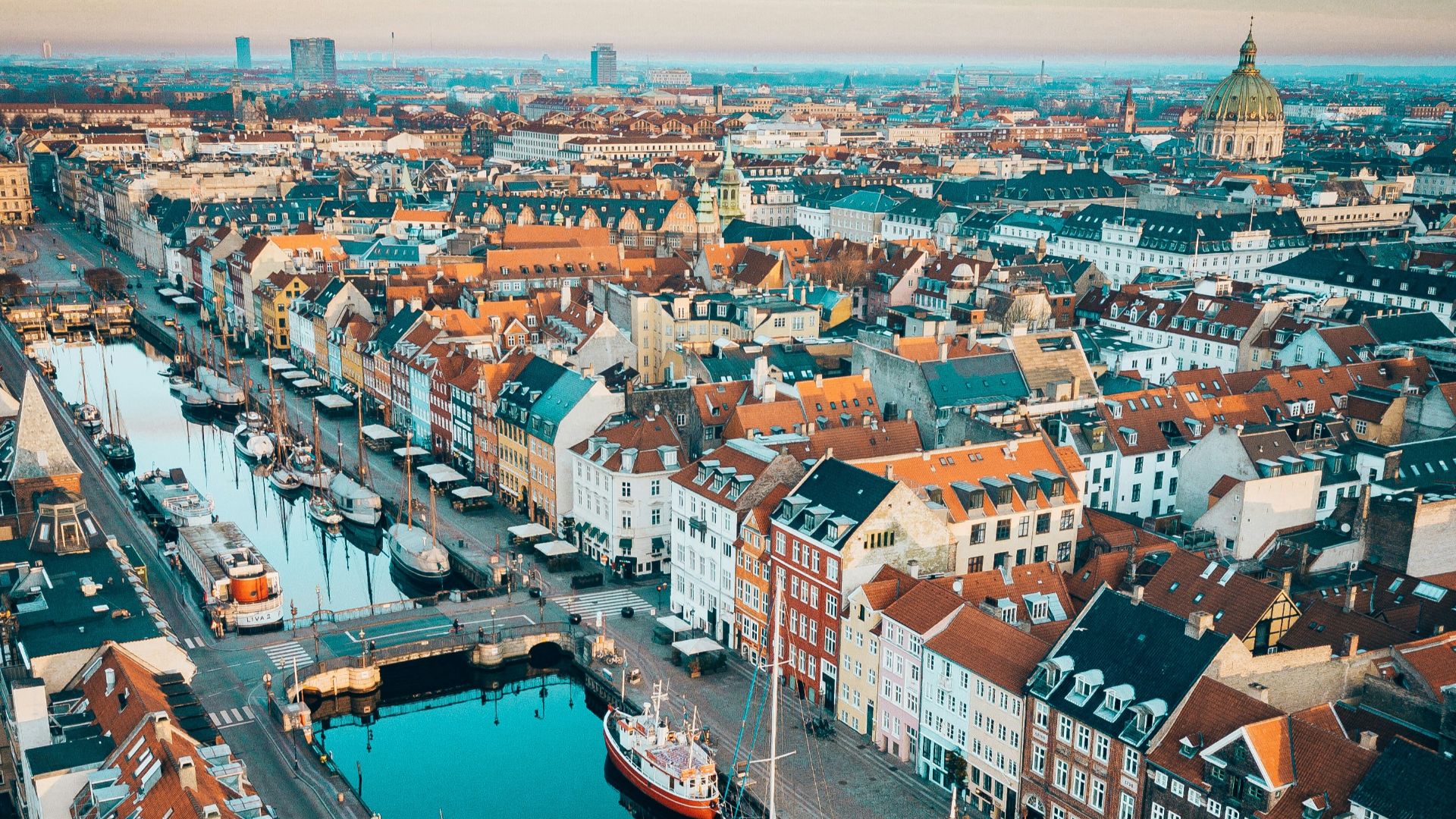 aerial photo of boats in between concrete buildings during daytime