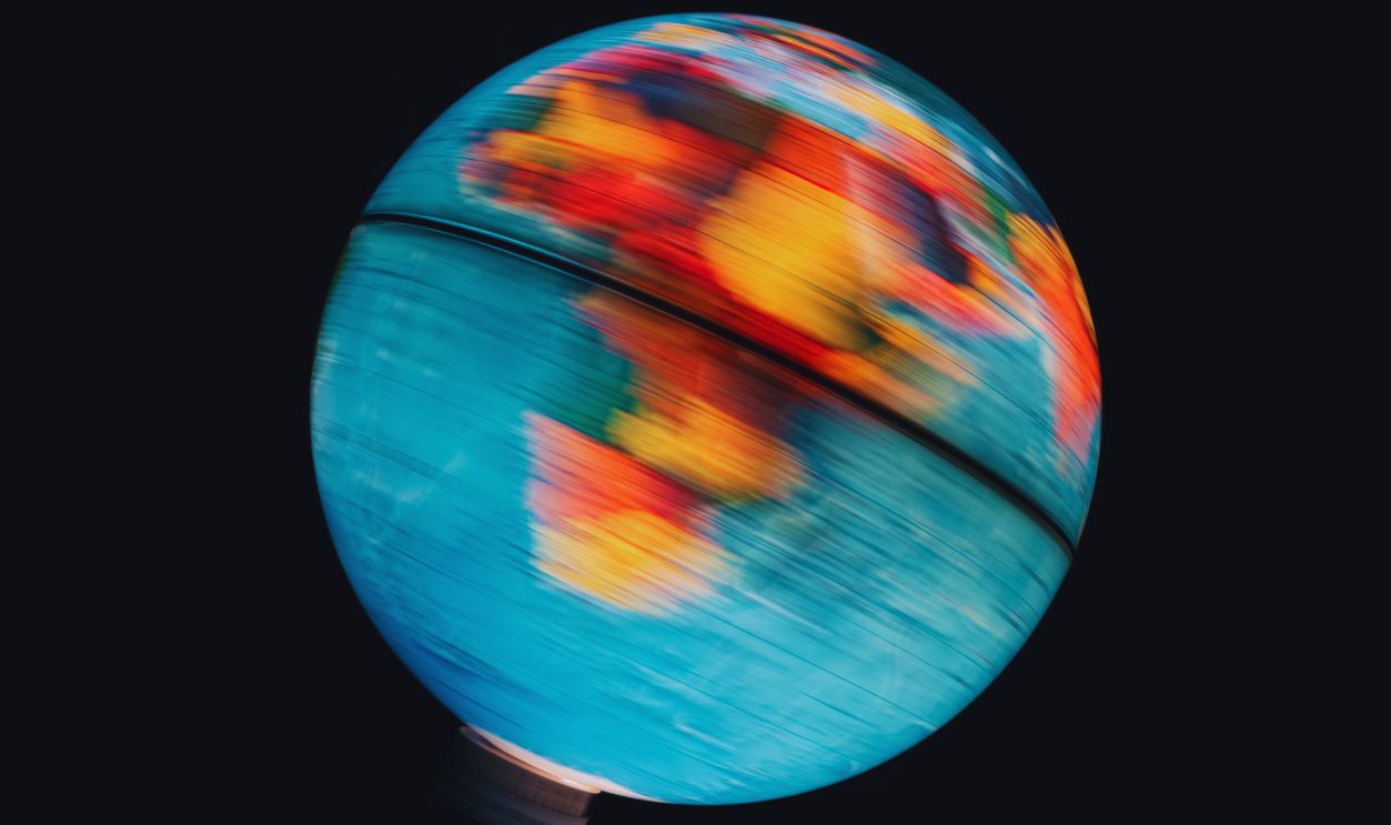 Gettyimages - 1217854136, Illuminated world globe spinning with black background - stock photo Illuminated world globe spinning with black background