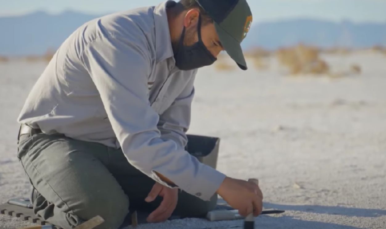 archaeologist studying ancient footprints