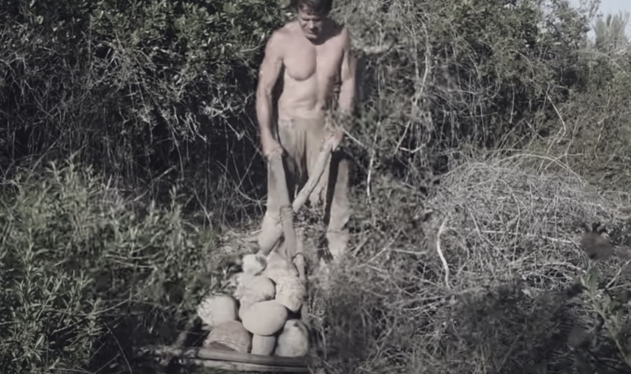 human pulling travois by hand