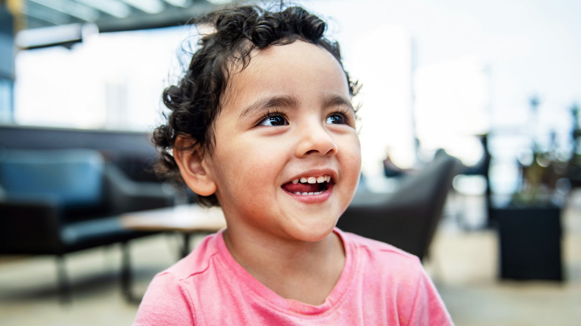 girl in pink crew neck t-shirt smiling
