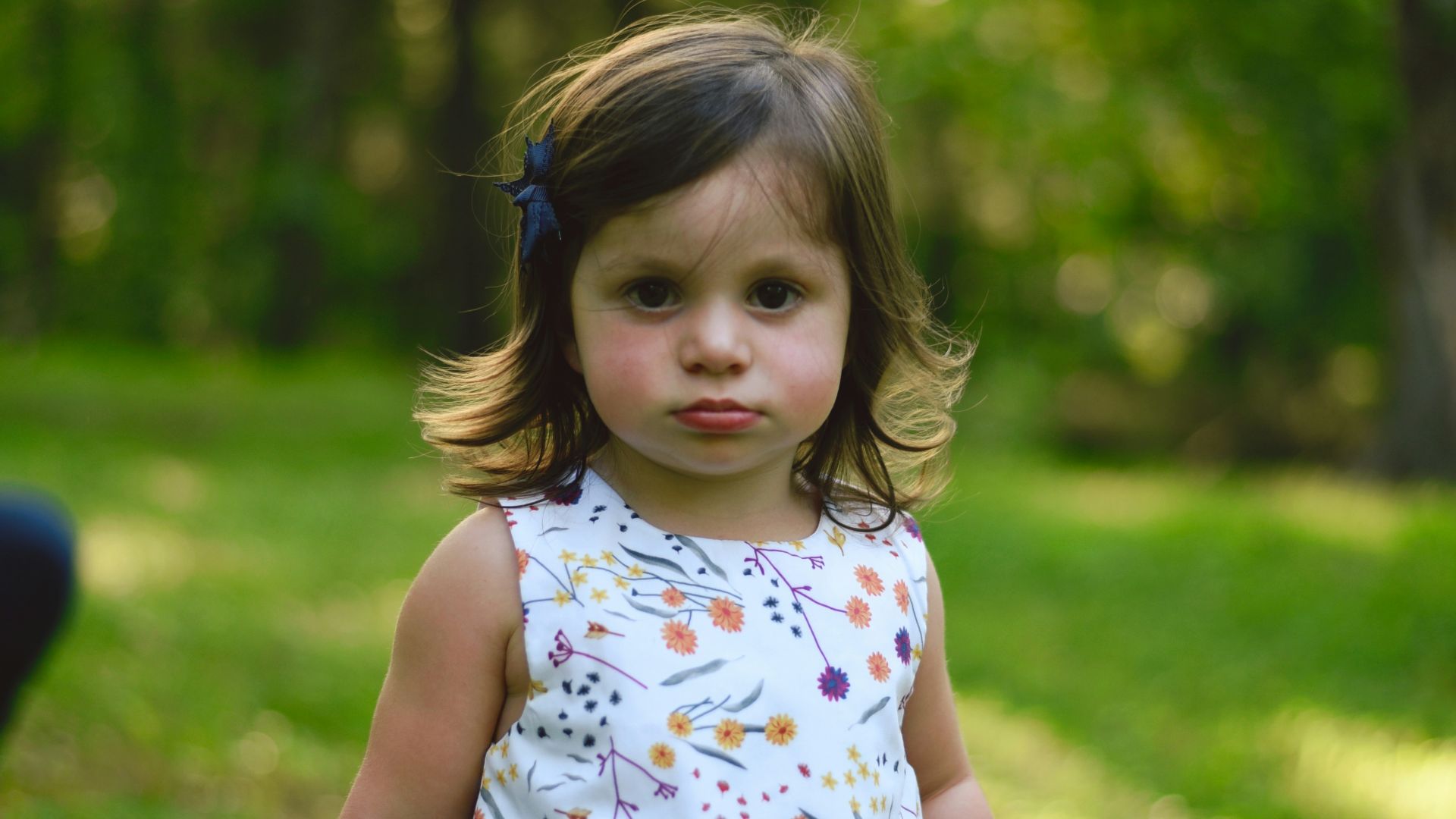 toddler girl standing on grass