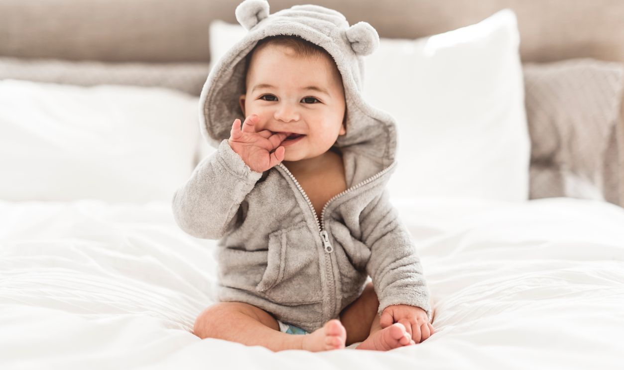 A Portrait of a baby boy on the bed in bedroom