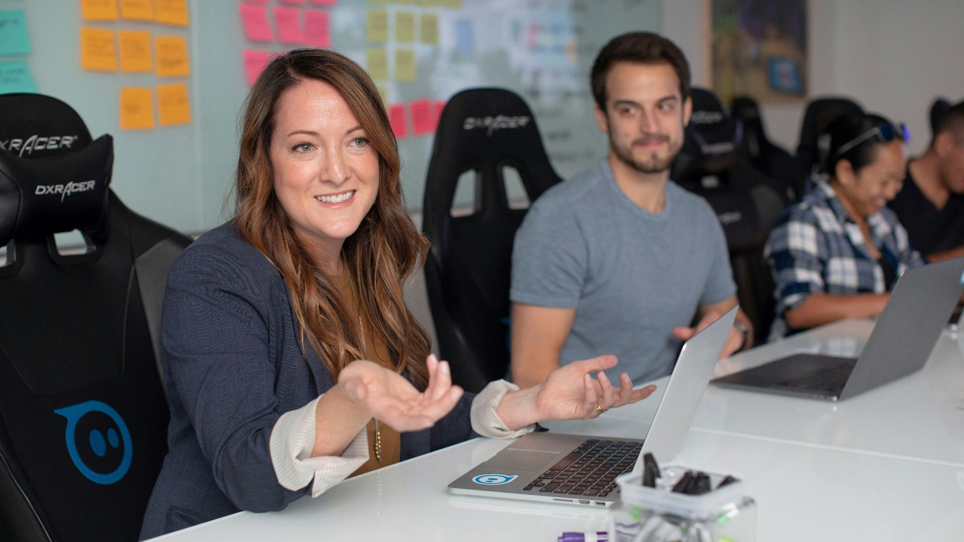 woman in black long sleeve shirt sitting beside man in gray crew neck shirt