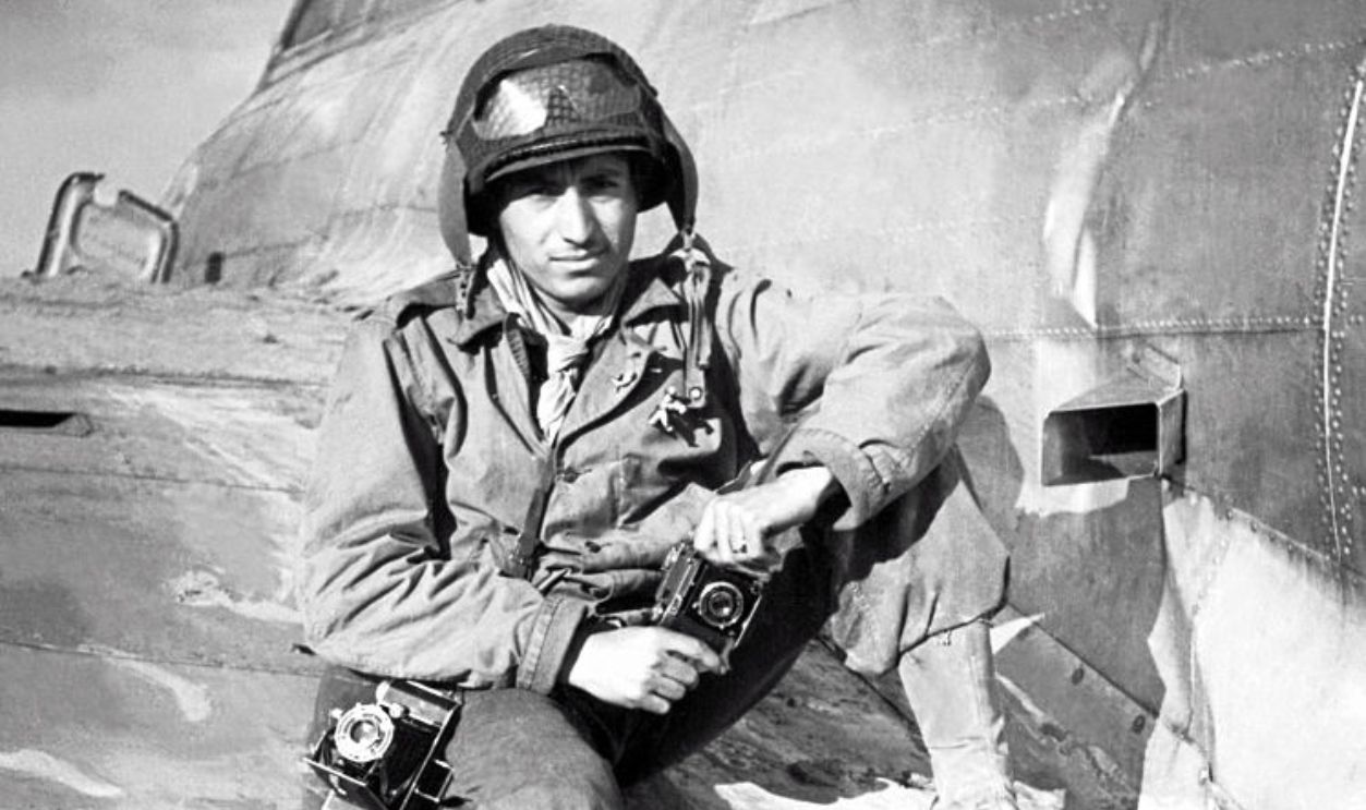 American GI Tony Vaccaro sits on the wing of a downed B-17 Flying Fortress, Mondorf-Les-Bains, Luxembourg, World War II, September 1944.
