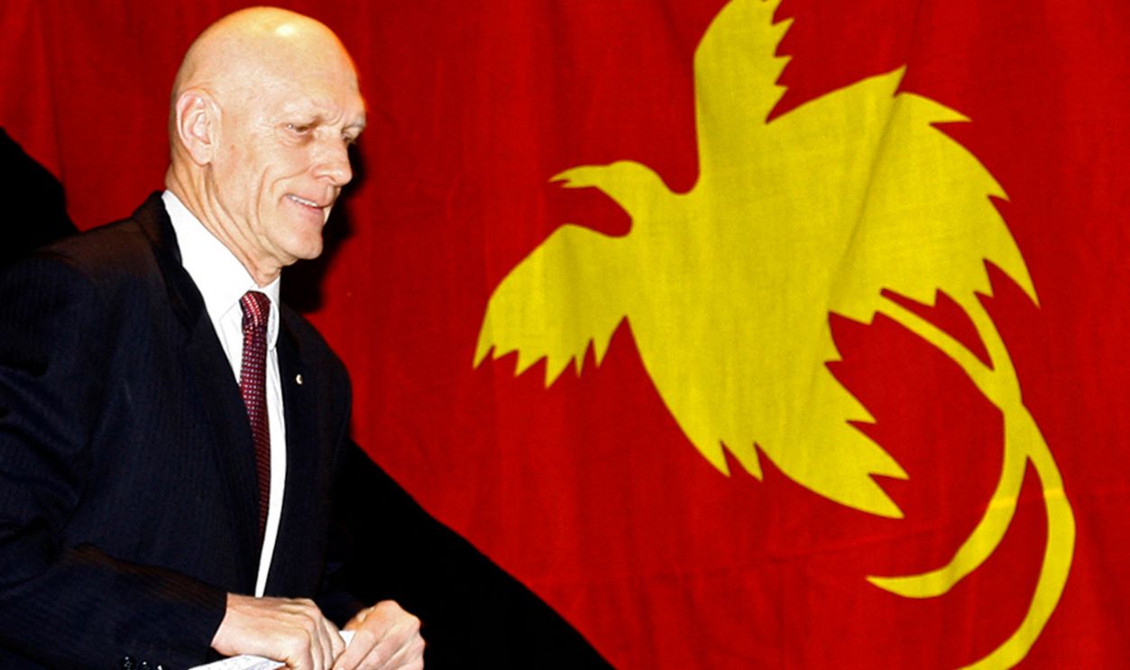 Peter Garrett, AUSTRALIA-WWII-MONTEVIDEO MARU This photo taken on July 2, 2011 shows Peter Garrett, Australian minister for school education, early childhood and youth and patron of the Rabaul and Montevideo Maru Society whose grandfather perished on the 'Montevideo Maru', passing the national flag of Papua New Guinea as he arrives to speak at the National Press Club in Canberra to commemorate the 69th anniversary of the sinking of the Japanese ship 'Montevideo Maru' off the Philippines on July 1, 1942. The ship was carrying 1,053 POWs and civilian internees captured by the Japanese in Rabaul, Papua New Guinea.