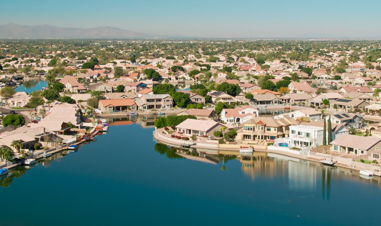 Drone shot of residential streets built around an artificial lake in the Arrowhead Ranch neighborhood of Glendale, a suburb of Phoenix, Arizona. Authorization was obtained from the FAA for this operation in restricted airspace.