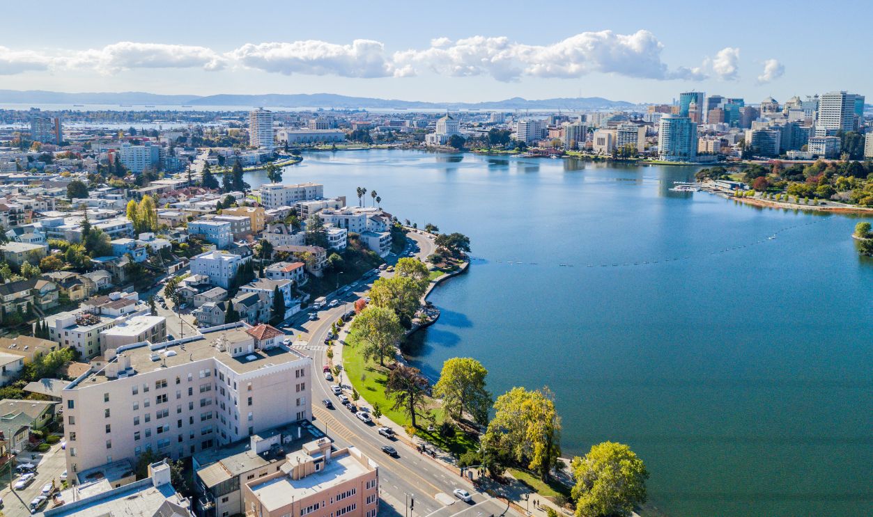 Aerial view above Lake Merritt in Oakland, California. Looking across the lake at downtown Oakland with skyscrapers in the distance.