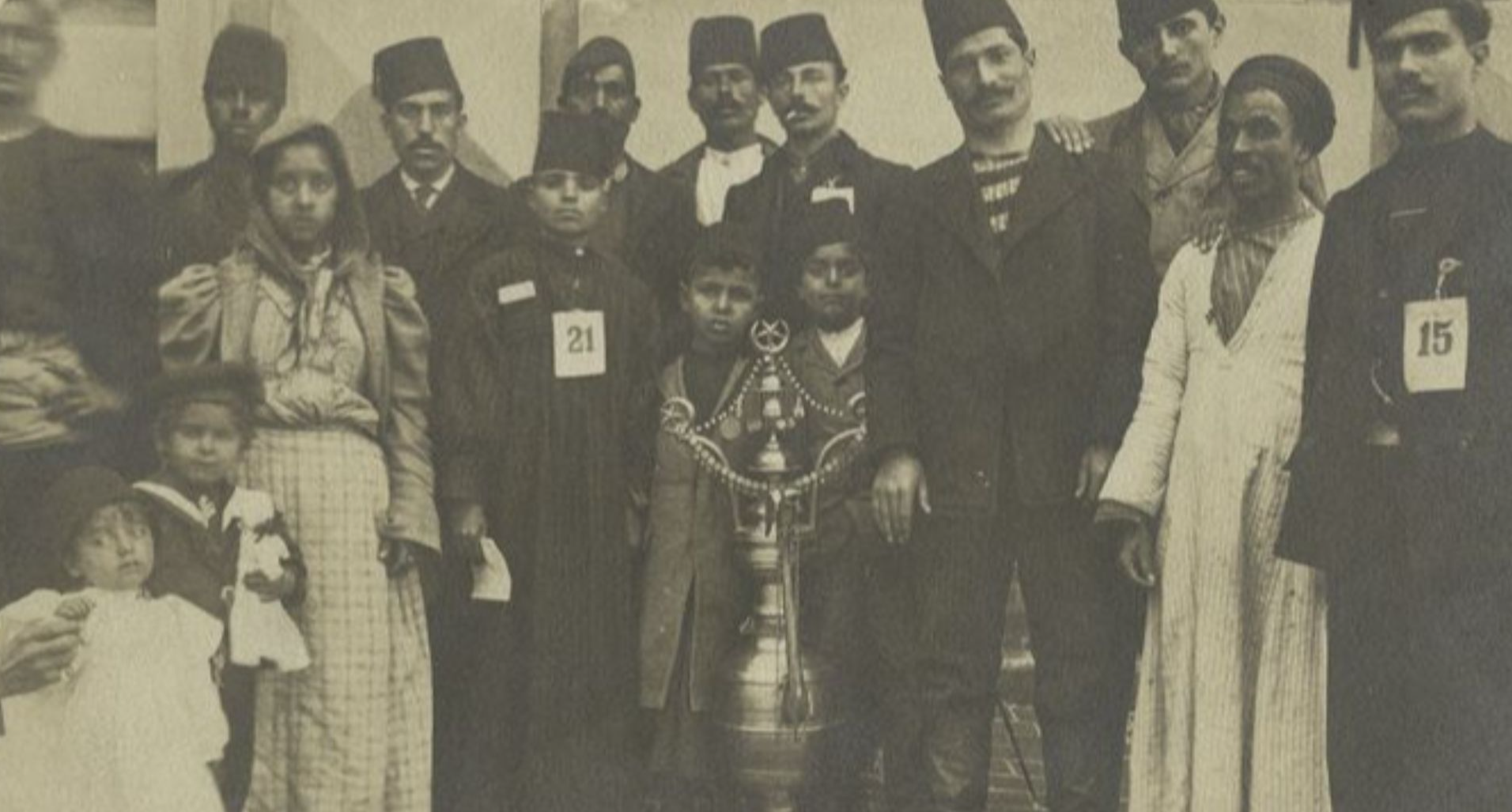 File:A group of immigrants, most wearing fezzes.jpg
