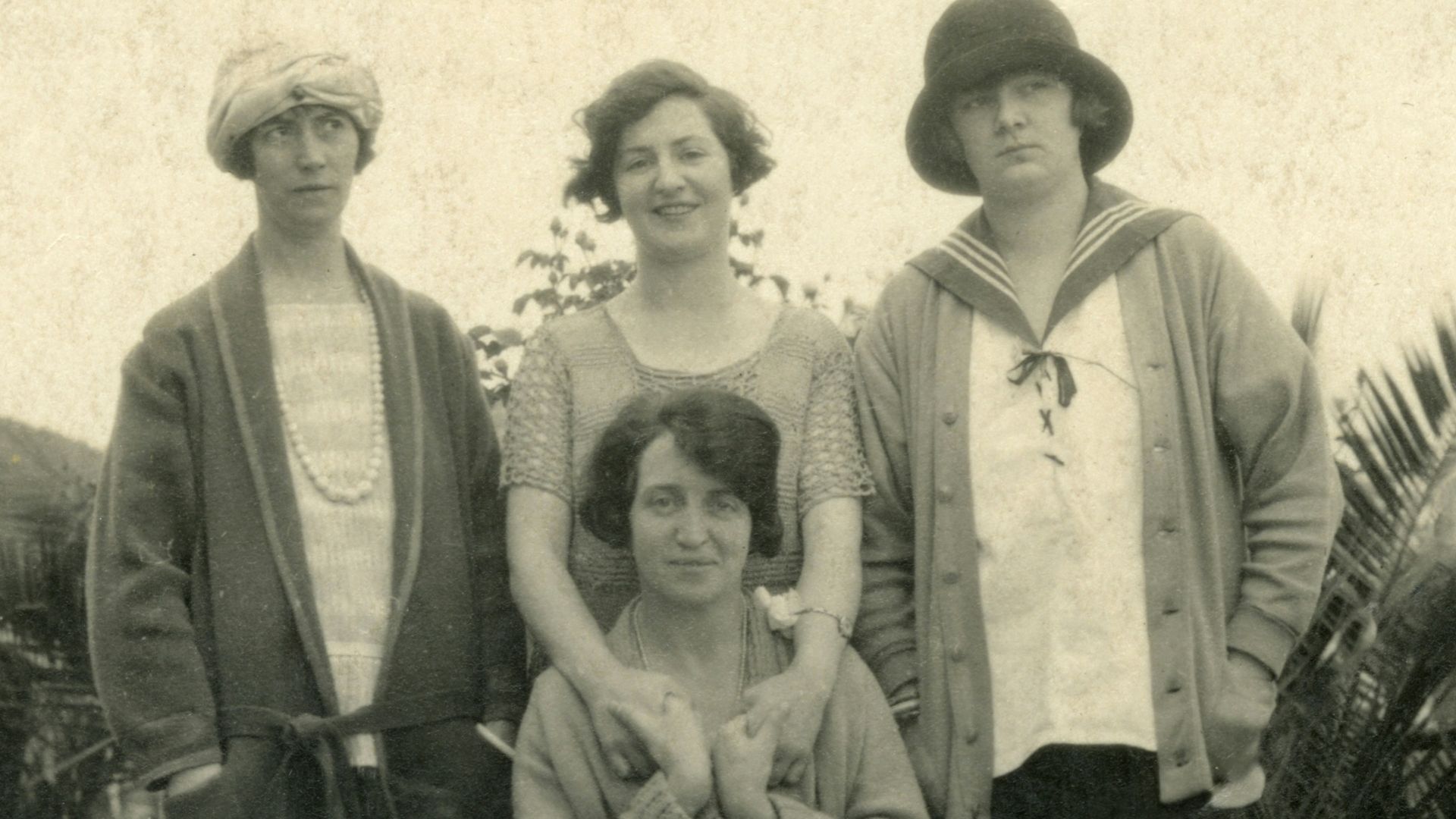 grayscale photo of 3 men and 2 women