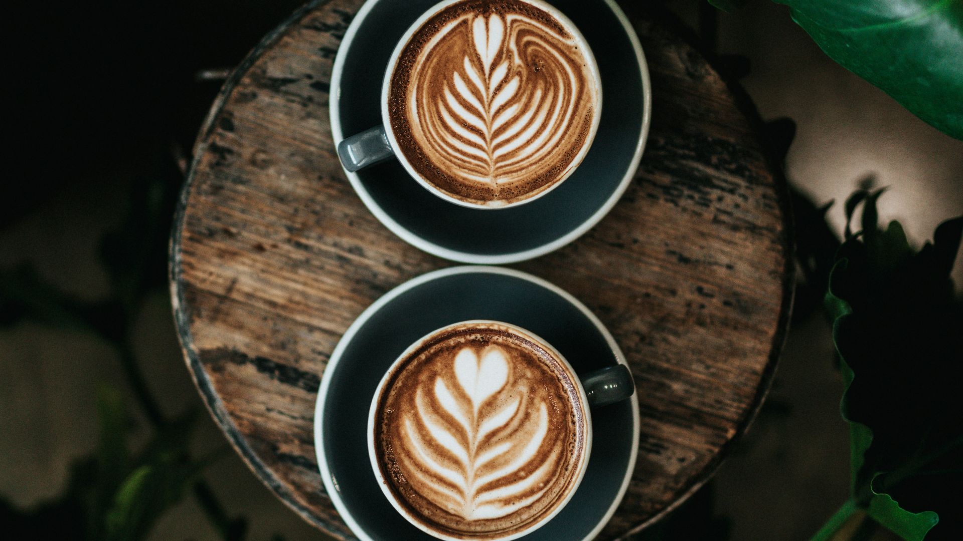 high angle photo of two green mugs filled with coffee