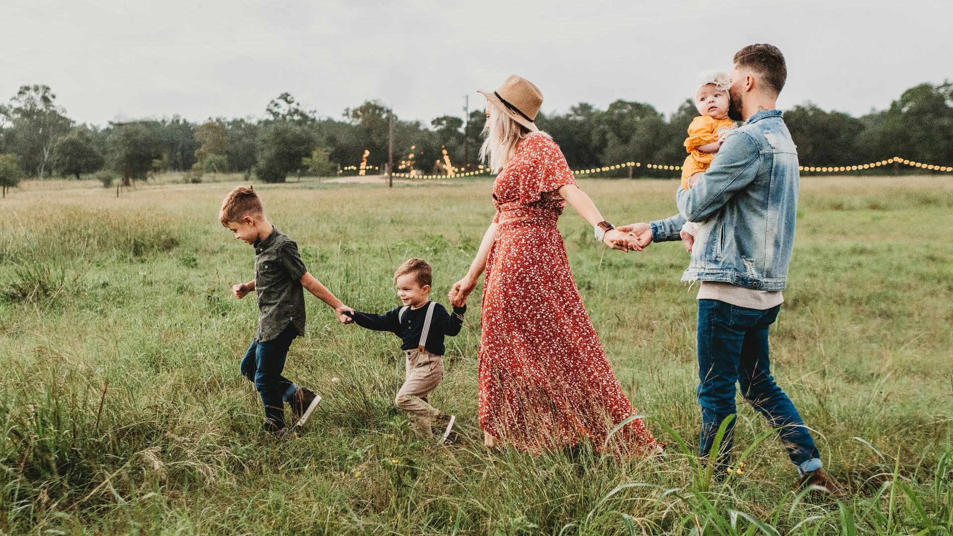 woman holding man and toddler hands during daytime
