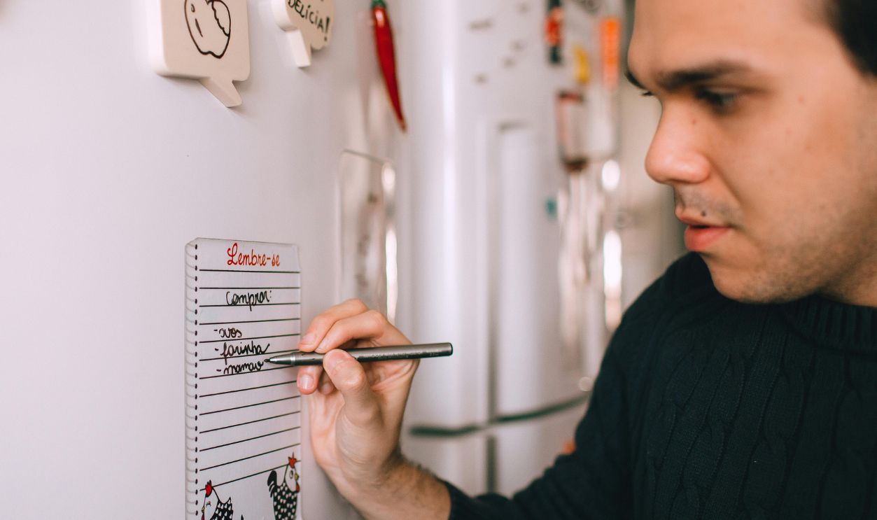 Man leaving a note on the fridge