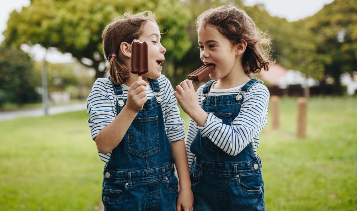 Two girls eating candy