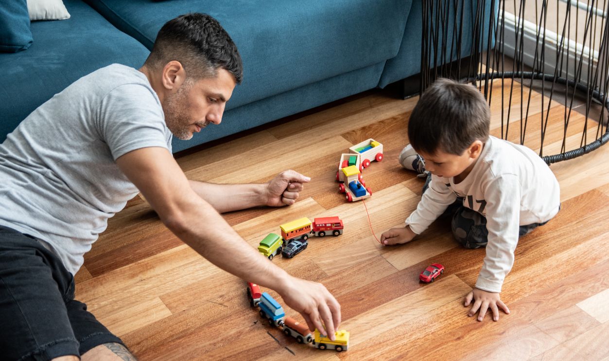 Father and son playing with train sets