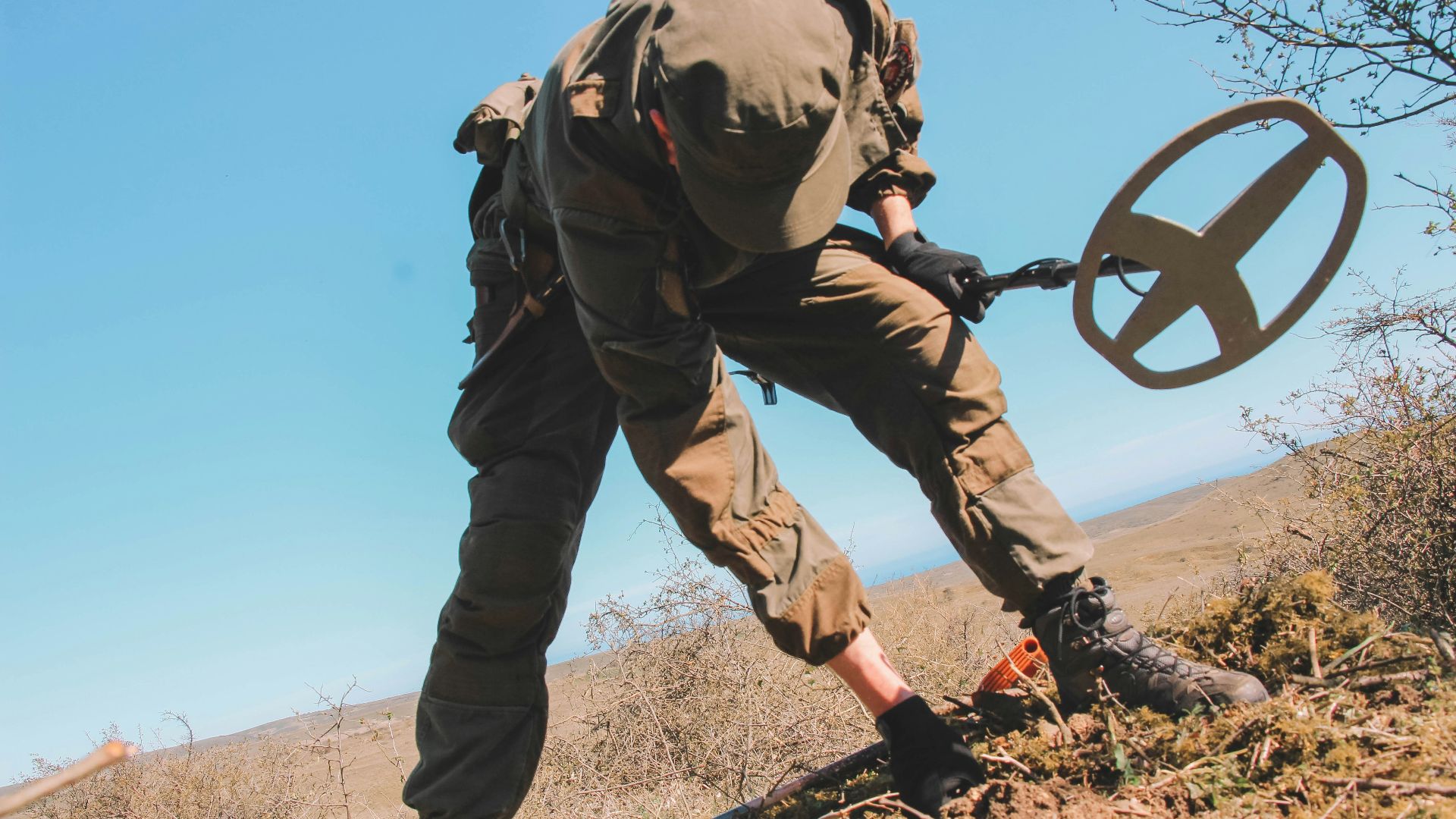 officer holding metal detector