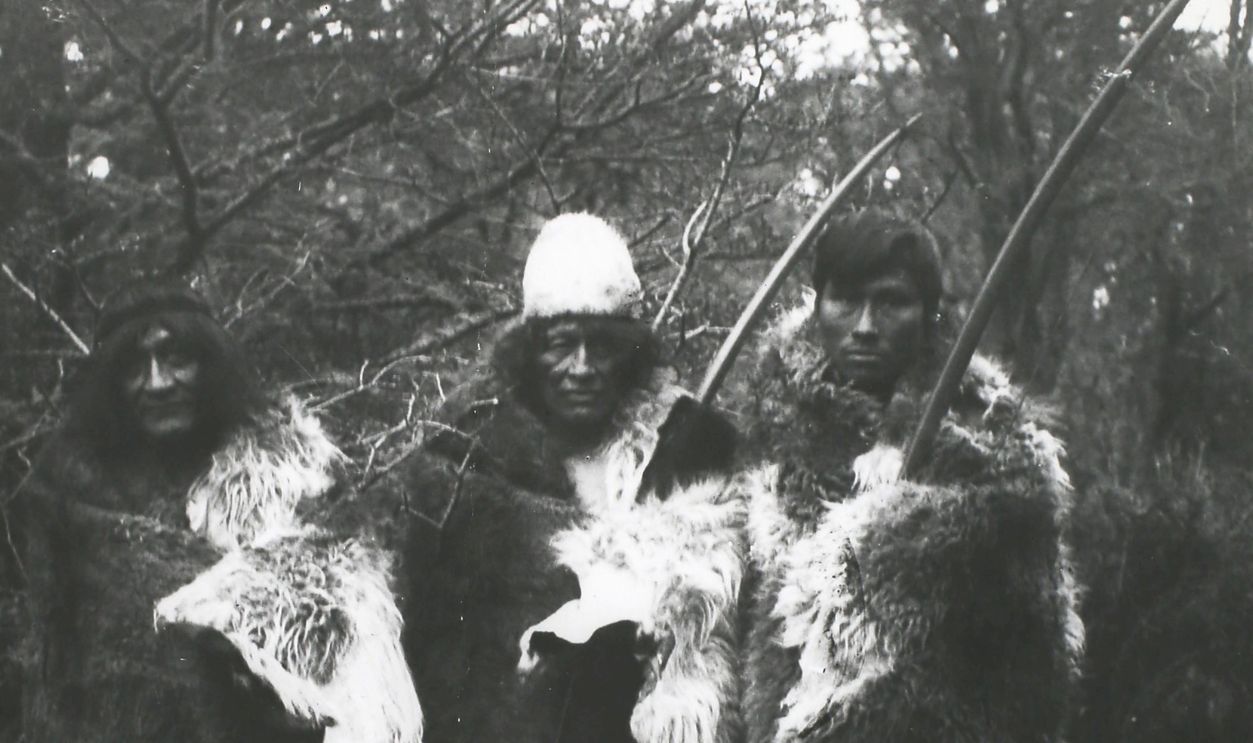 People of the Ona or Selk'nam tribe, an indigenous people who once occupied the interior of Terra del Fuego in South America, wearing their habitual costume of furs, circa 1890-1900. They subsisted by hunting and were expert archers. Their chief food was the flesh of the Guanaco, a wild camel related to the llama. In addition they ate birds, fish, shellfish, berries and fungi. Their dress was a large robe of guanaco fur, moccasins, a petticoat for the women and a fur diadem for the men. They rarely used houses and habitually slept behind a windbreak of hides. 