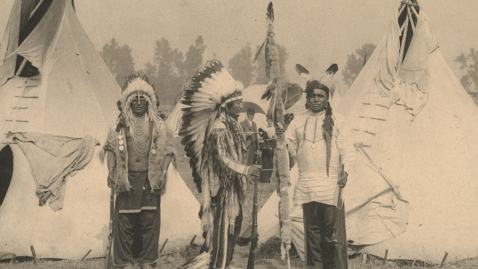 3 men in white and black coat standing on snow covered ground