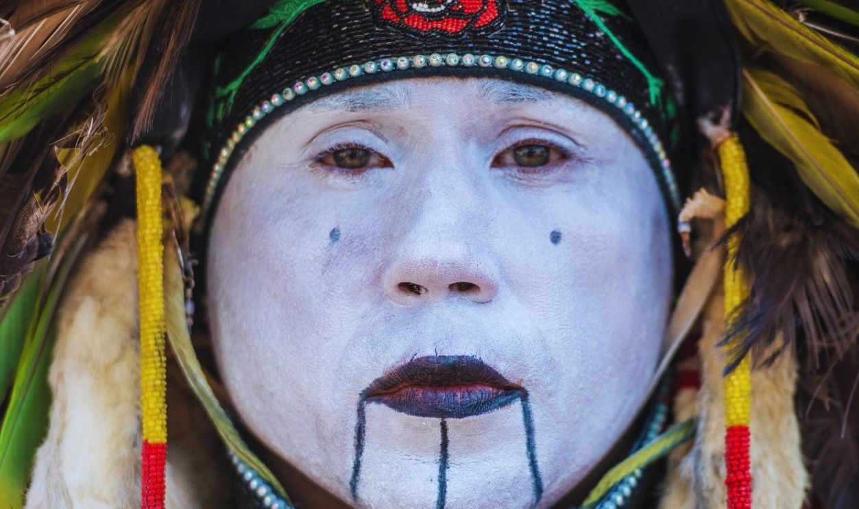 Gettyimages - 1162779697, Close up of male Native American dancer belonging to the Lumbee tribe wearing a traditional costume and face paint, Baltimore, Maryland