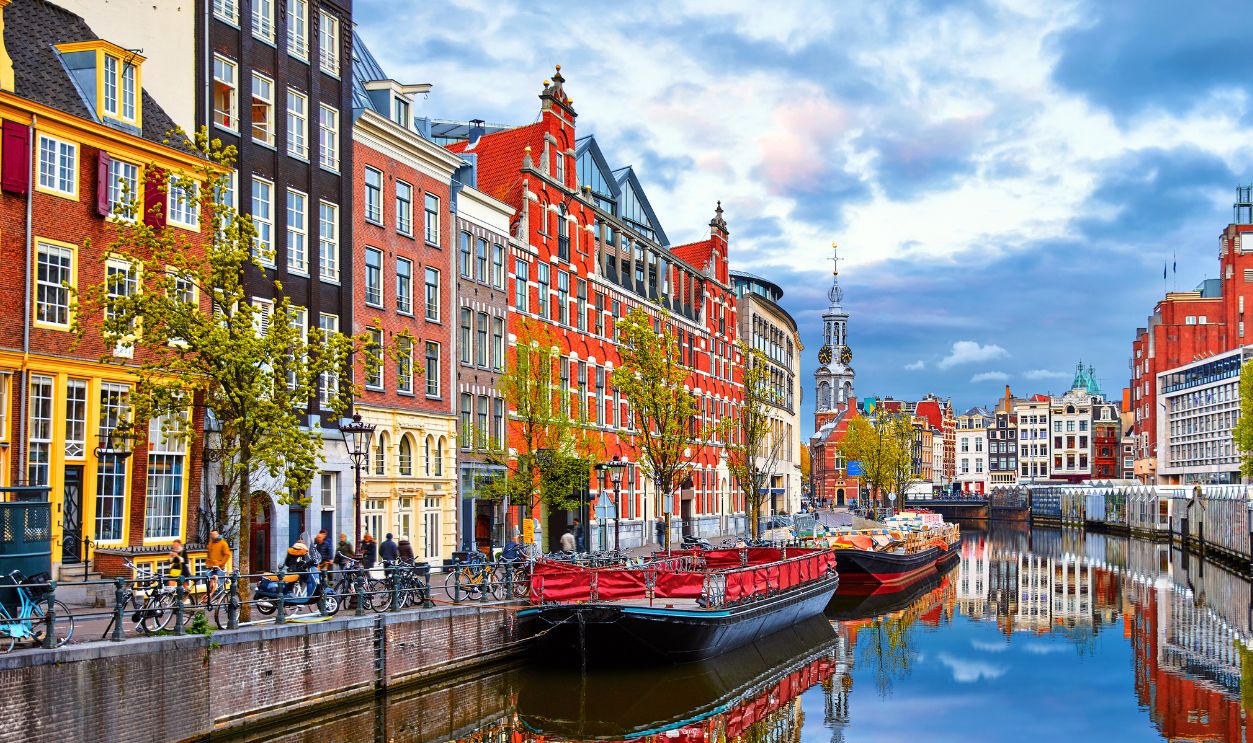 Channel in Amsterdam Netherlands houses river Amstel landmark old european city spring landscape.